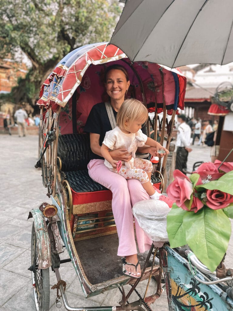 mum and daughter on a Rickshaw in Kathmandu
