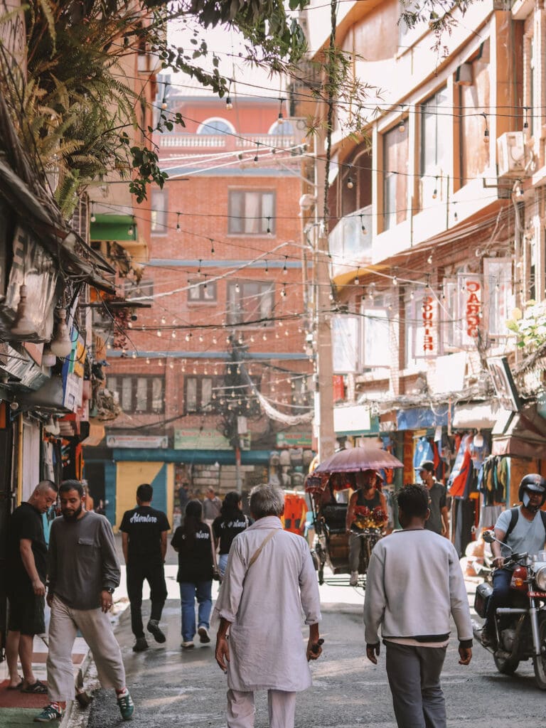people, bikes and Rickshaw on the street in Thamel
