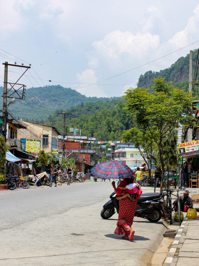 Mother and child crossing the road in Pokhara, Nepal
