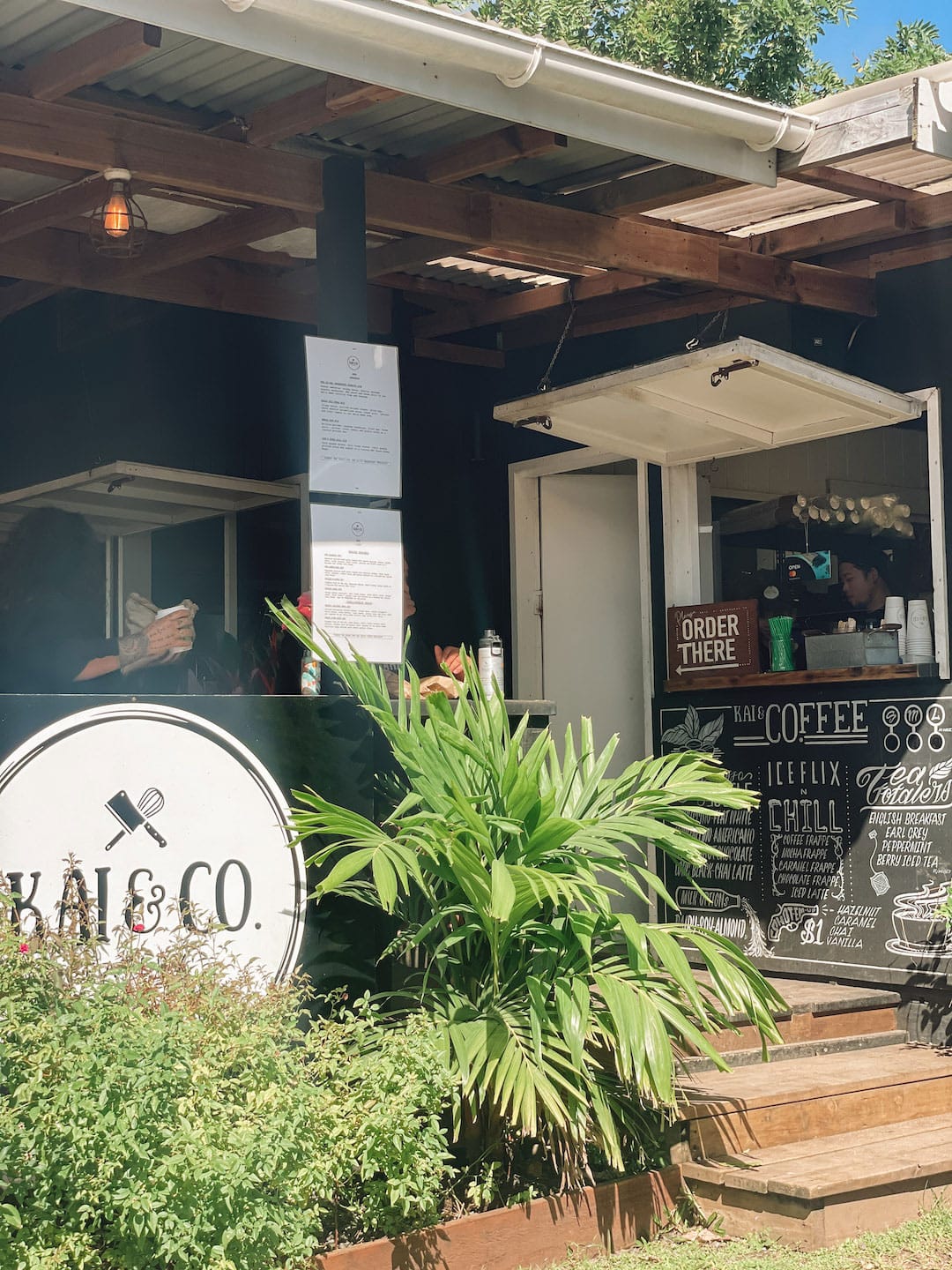 Charming coffee shop with outdoor seating and lush greenery in Rarotonga, Cook Islands